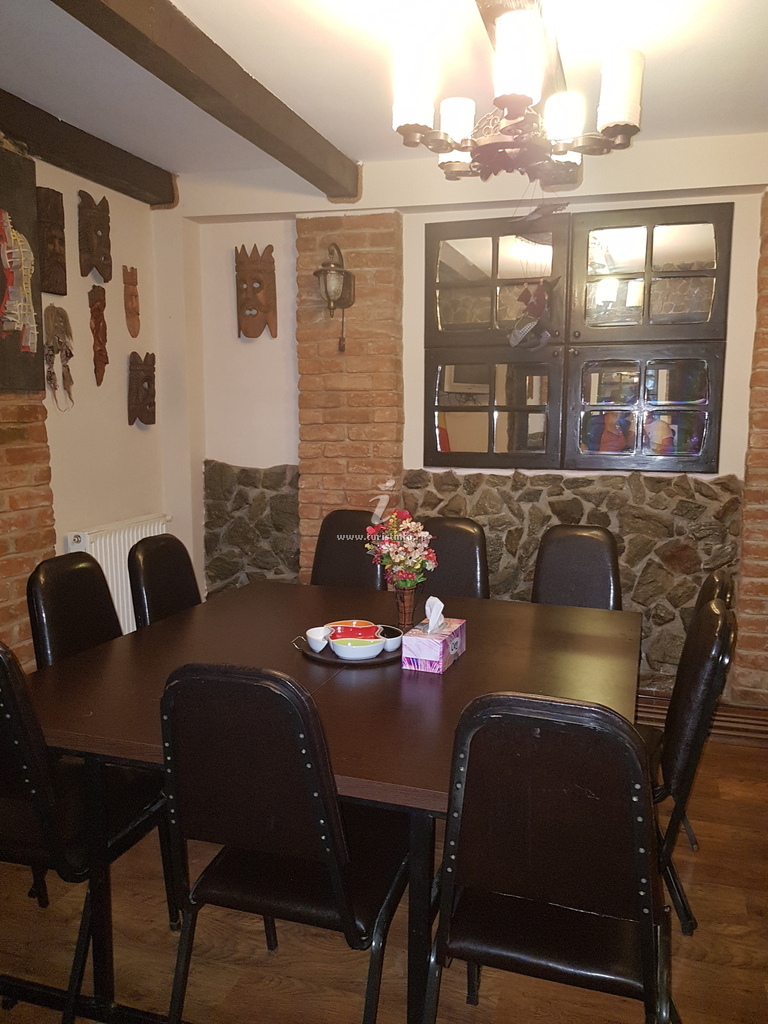 Sala de mese cu masă mare și scaune tapițate